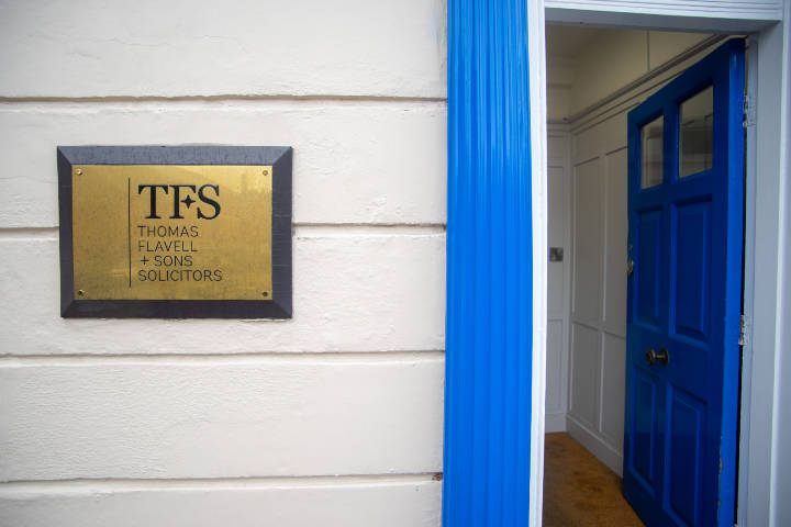 A photo of Thomas Flavell's Hinckley office plaque and front door
