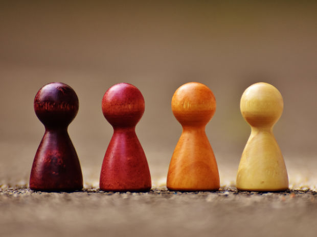 An image of aligned coloured pegs.